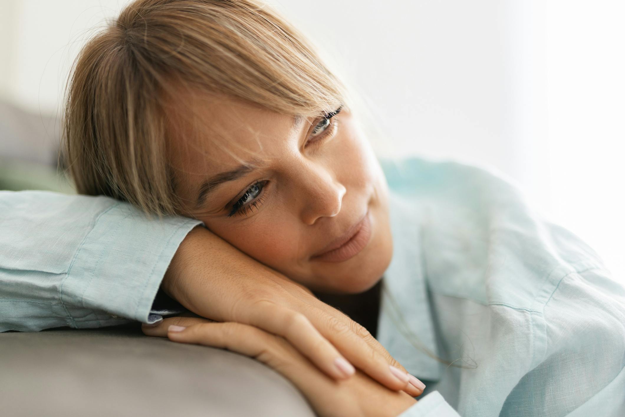 middle aged model with short hair wearing a green button down