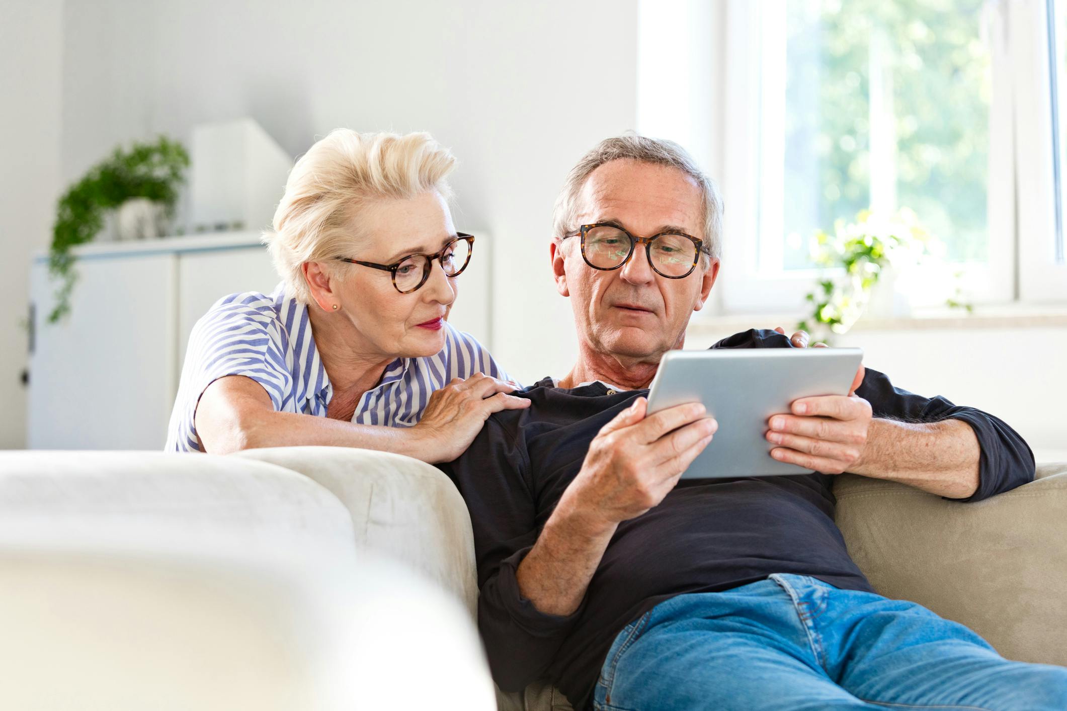 middle aged couple looking at a tablet