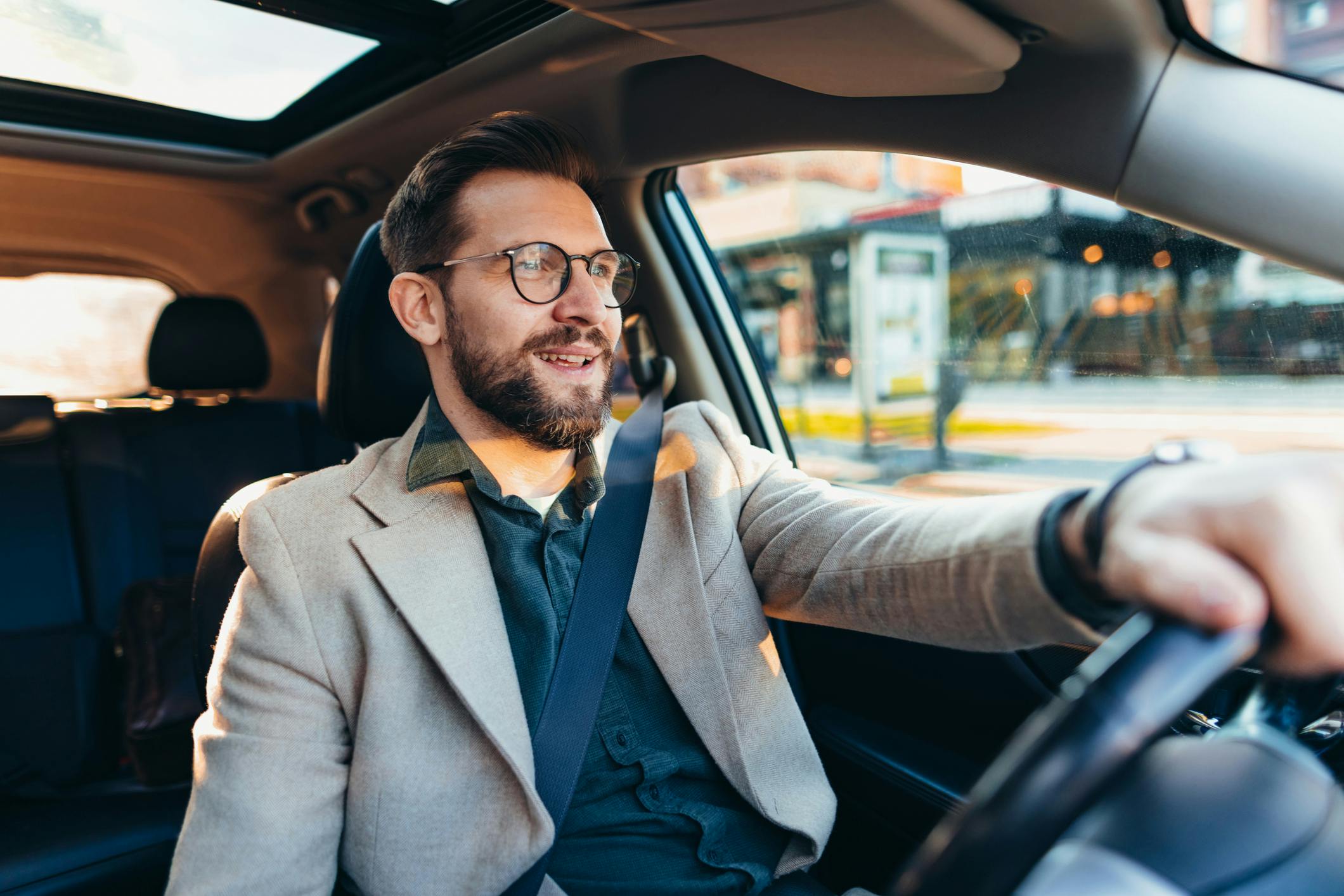 man driving his car in the city