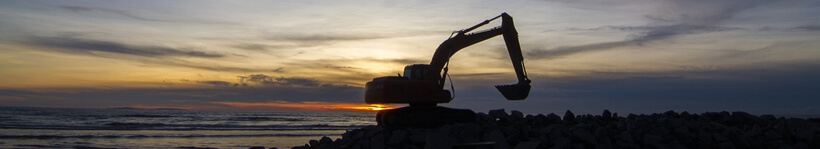 grävare i solnedgång