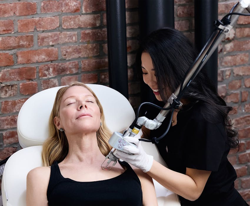 Chelsea Kim doing laser procedure on patient's lower neck area