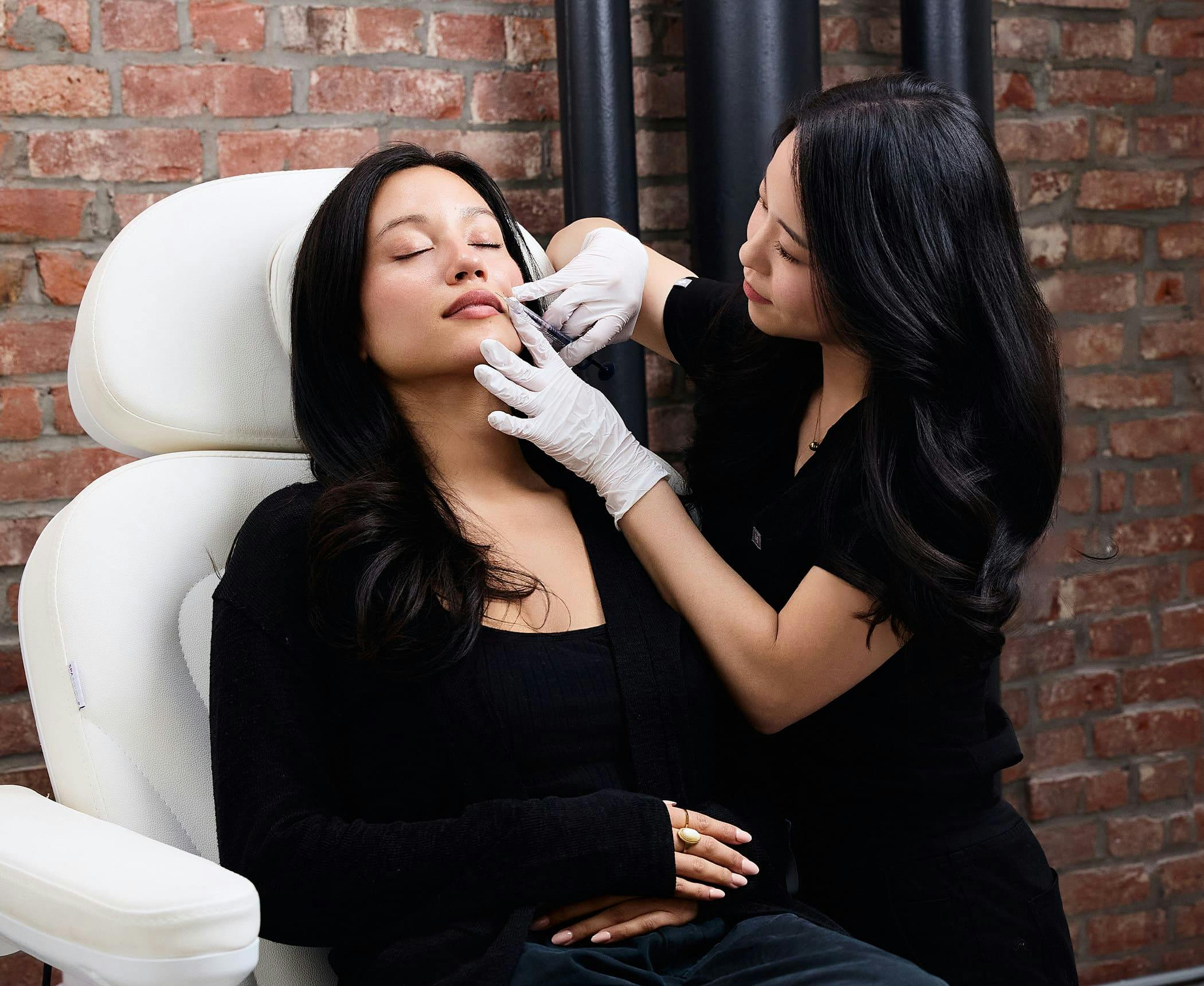 Chelsea Kim doing facial injection on patient