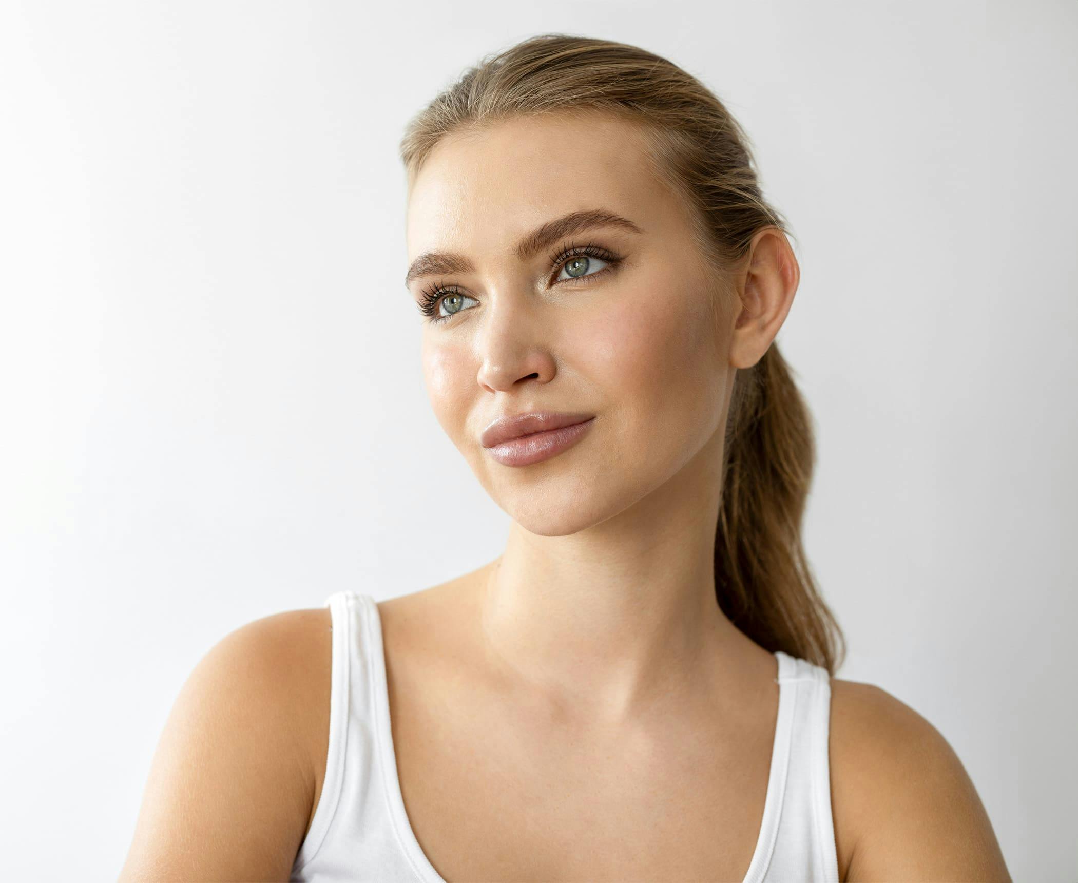 woman with ponytail looking off to the side