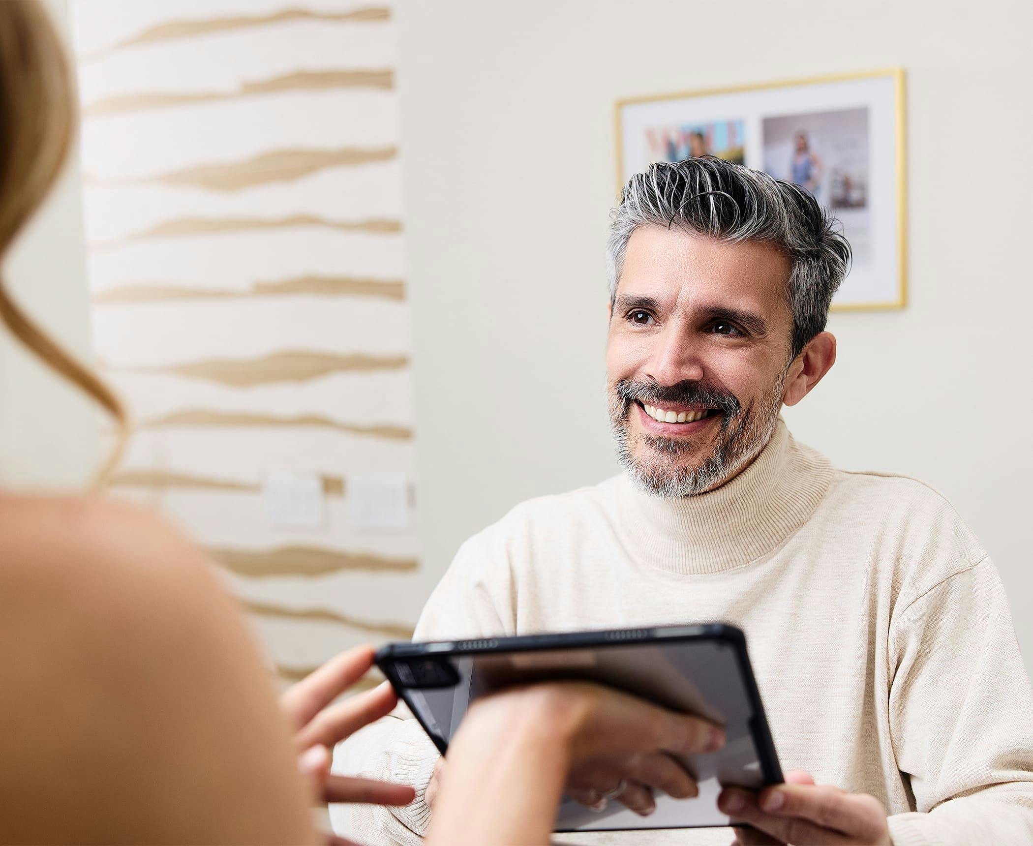 male patient getting handed an ipad