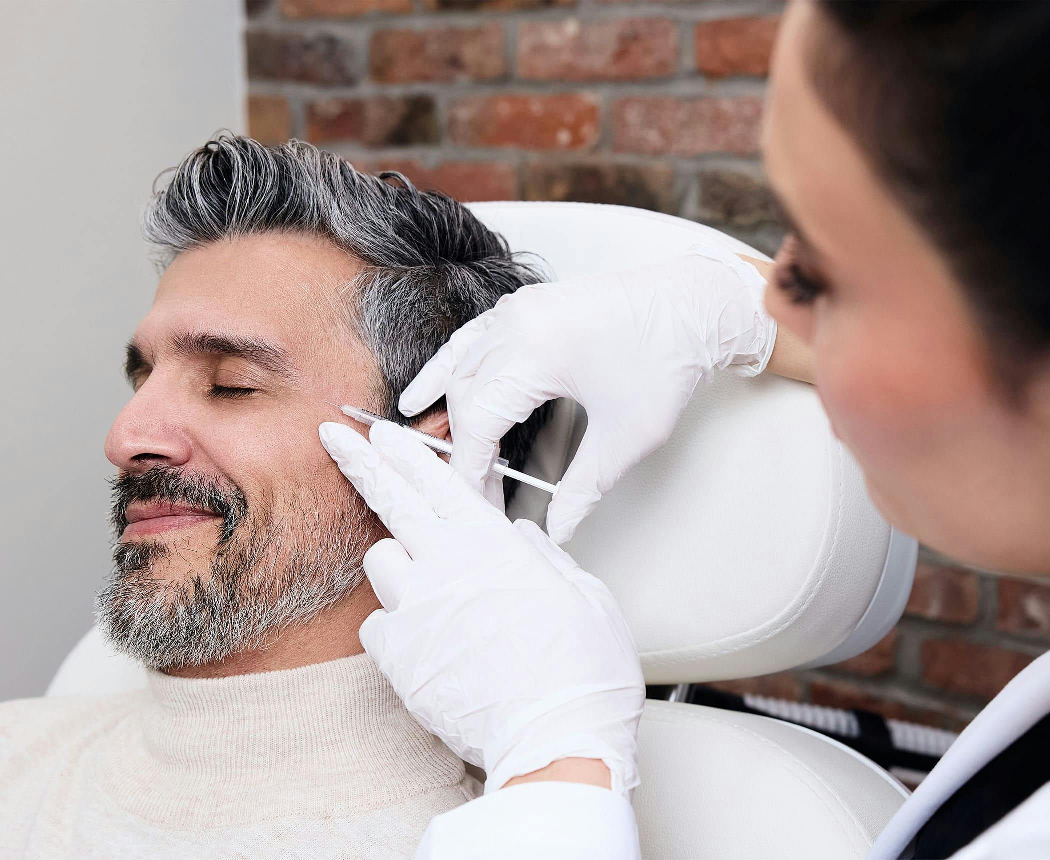 male client getting injection on his temples