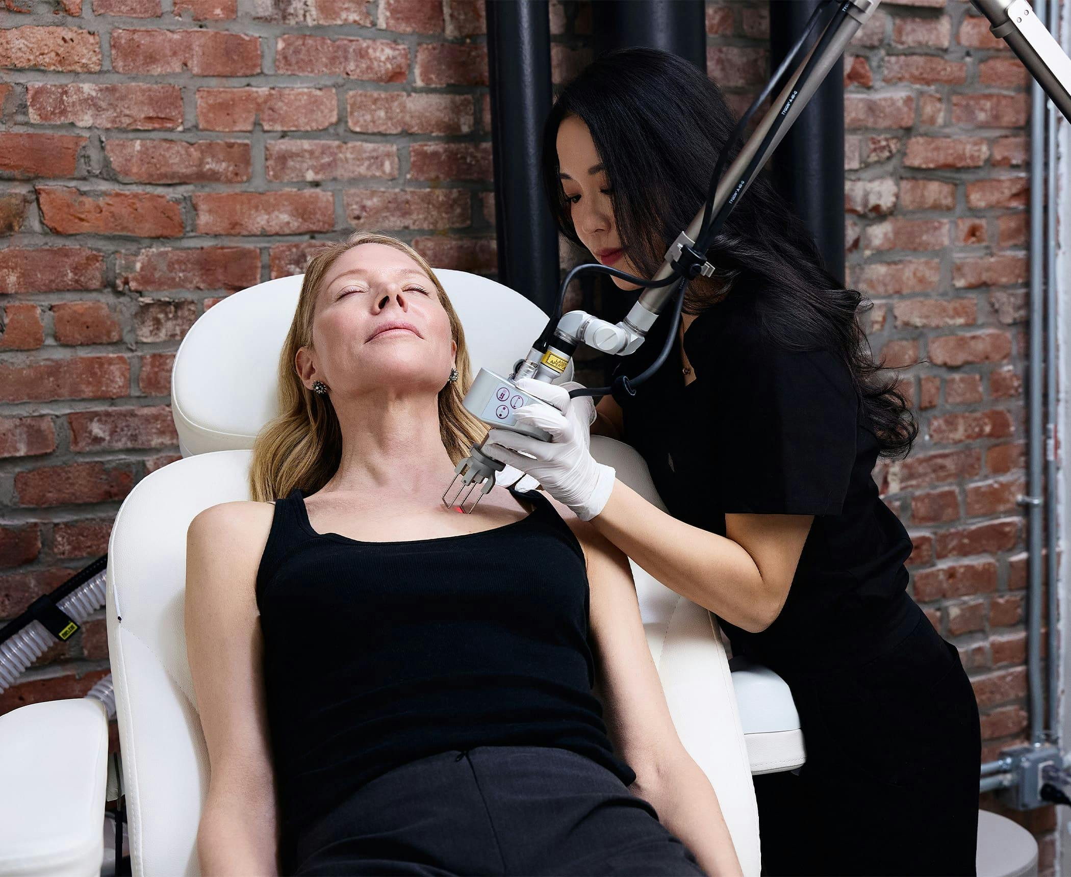 Chelsea Kim doing laser procedure on patient's upper chest