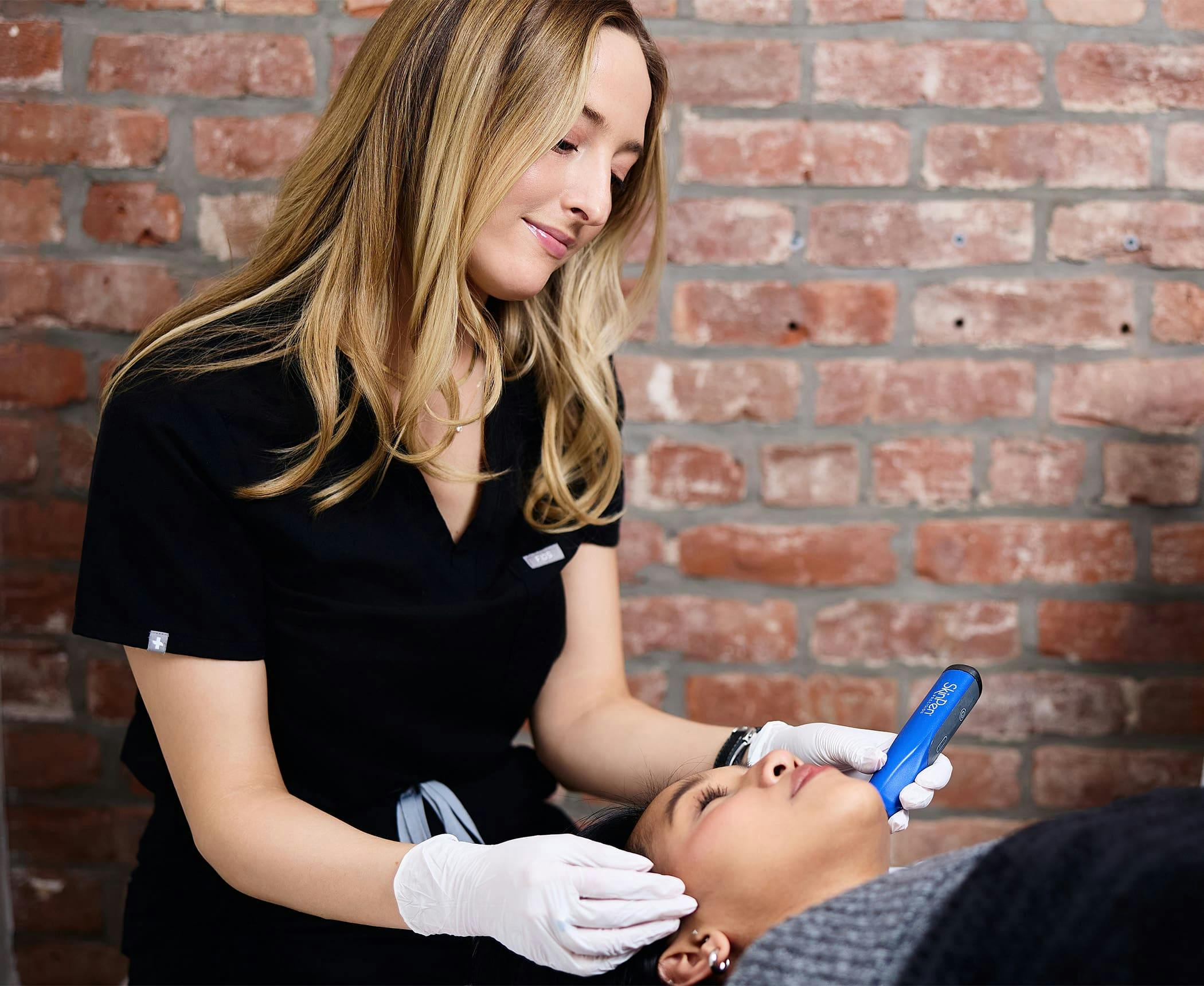 Camille Mckee doing microneedling procedure on patient