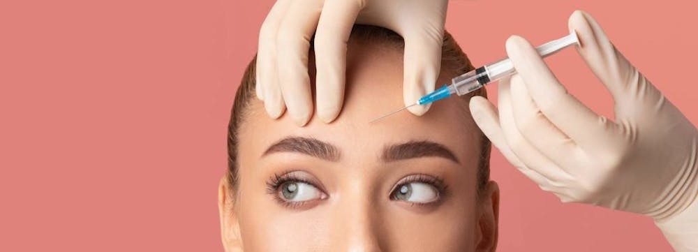 woman getting fillers in her forehead area