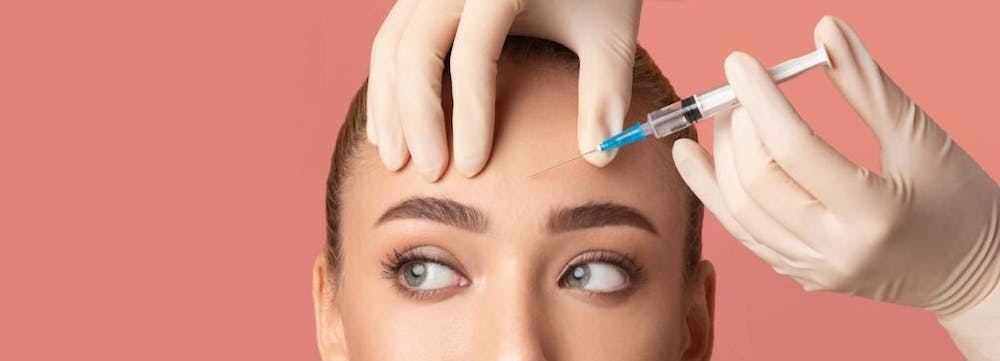 woman getting fillers in her forehead area