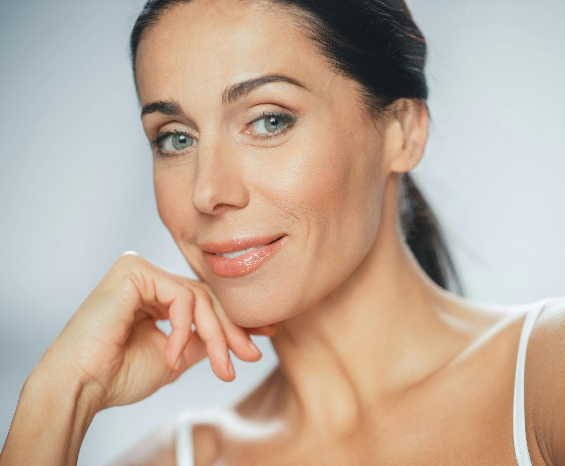 woman resting her hand on her chin