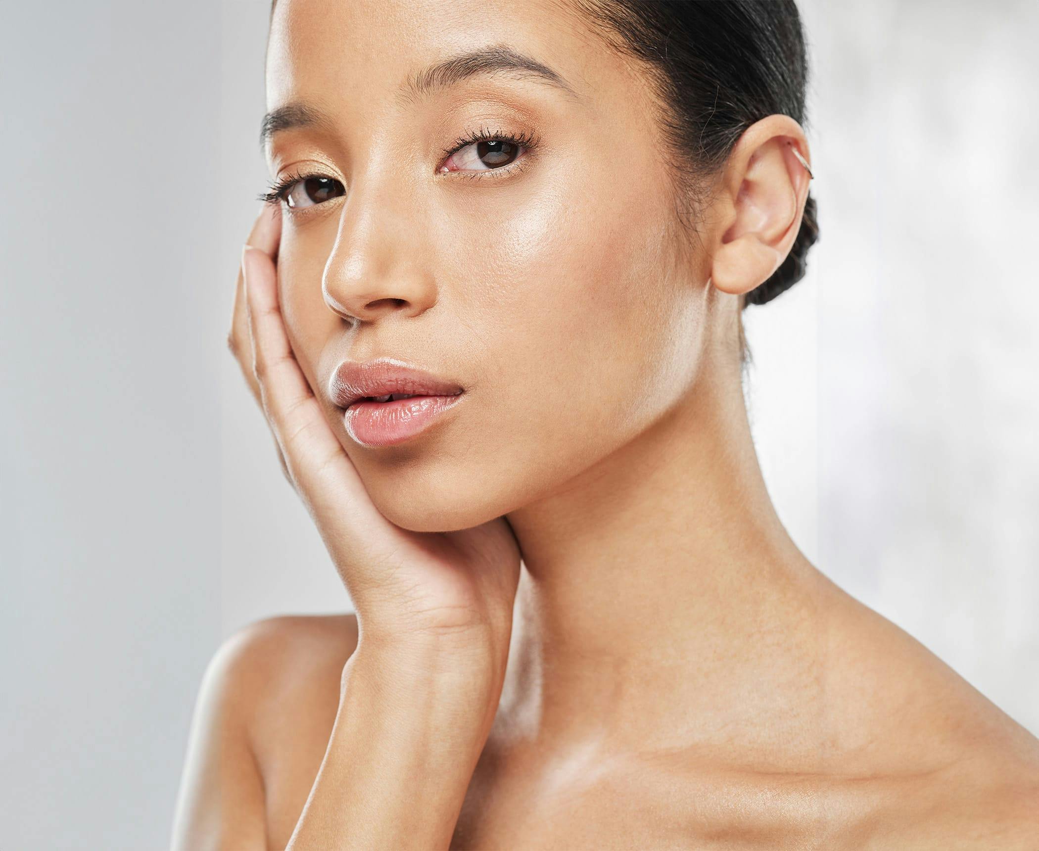 woman holding her cheek