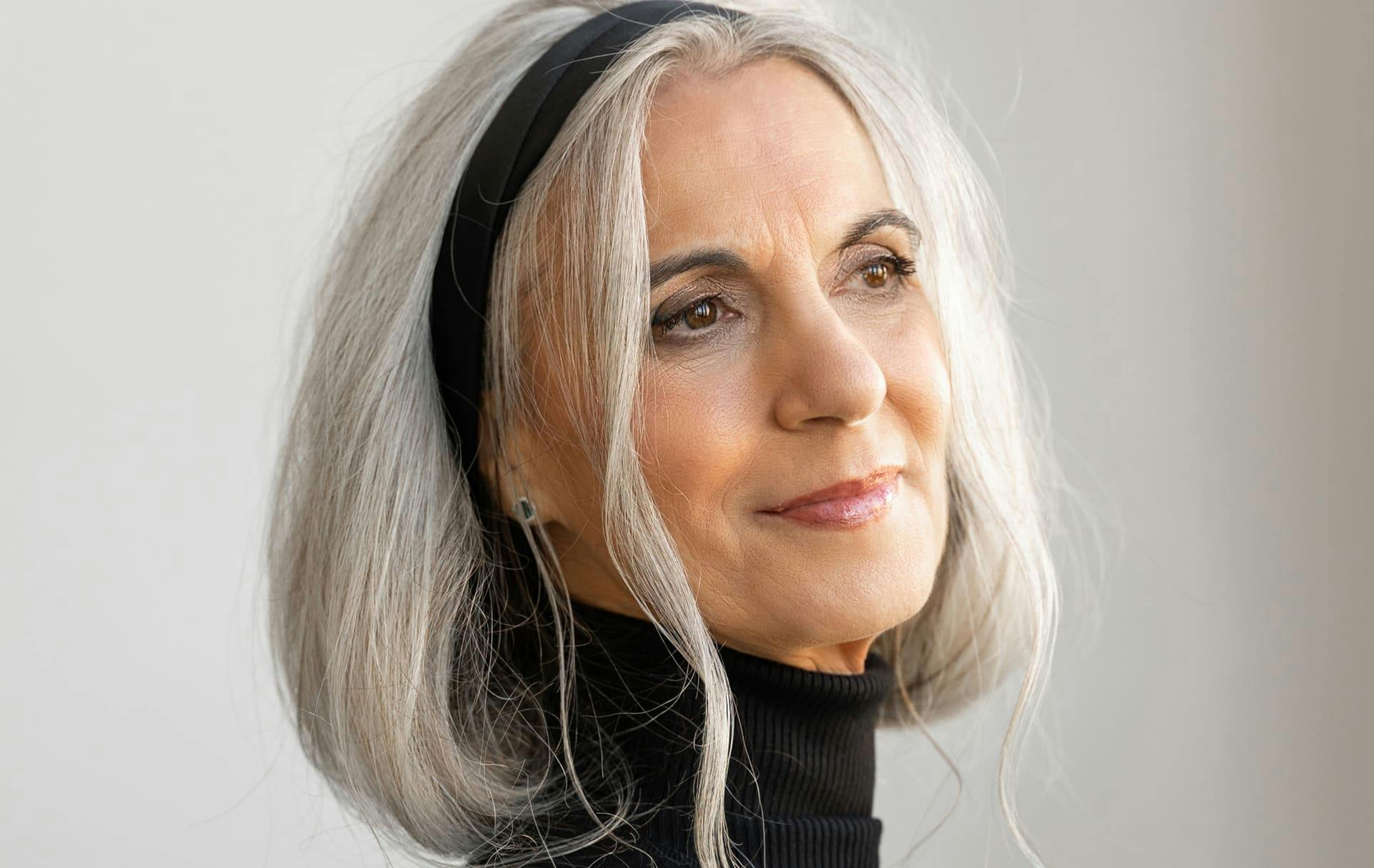 Woman in a turtle-neck smiling