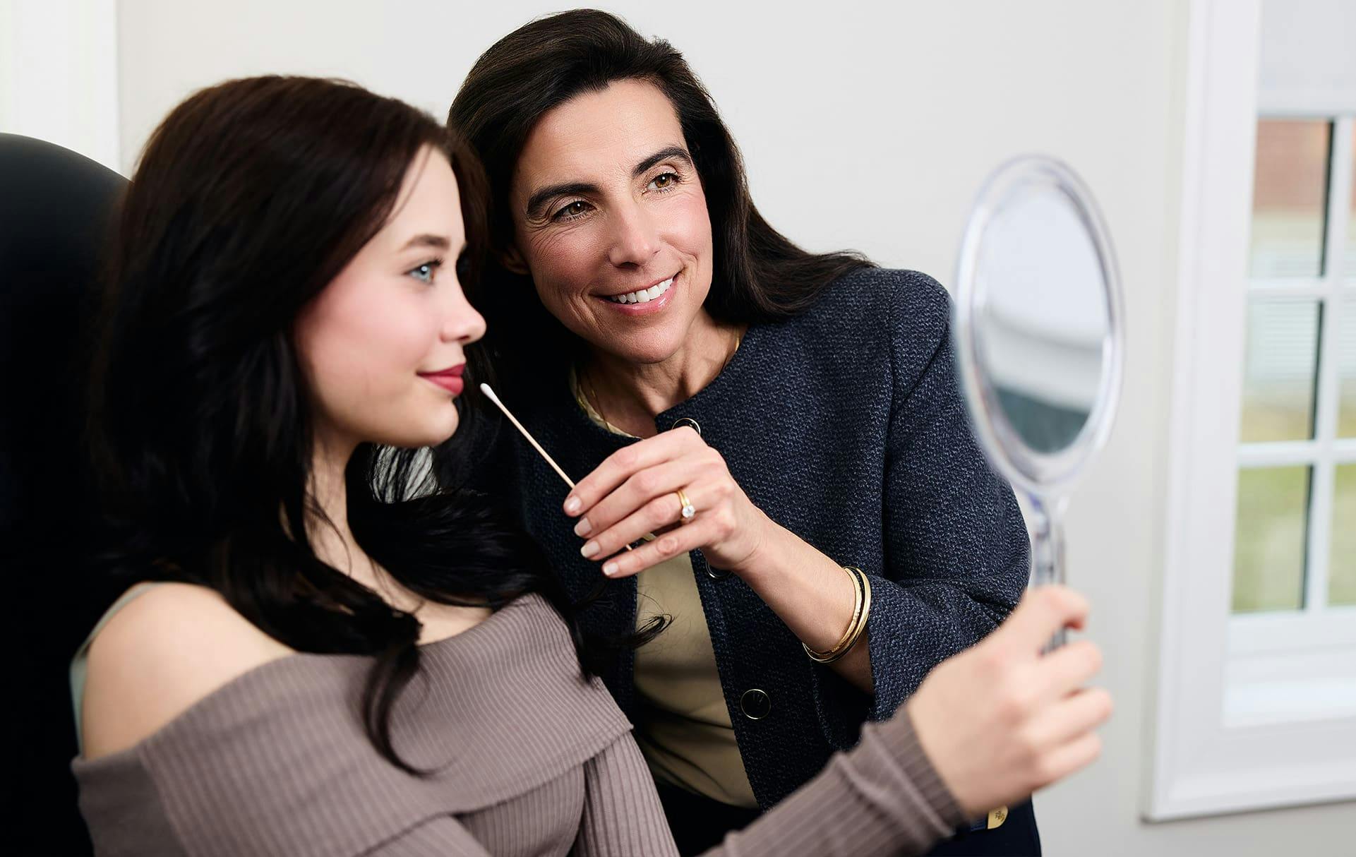 doctor touching patients face with cutip