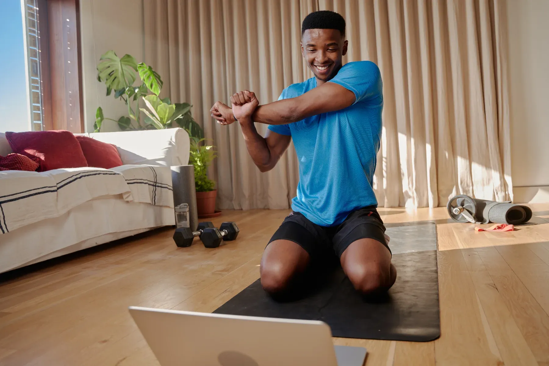 Happy man doing yoga at home