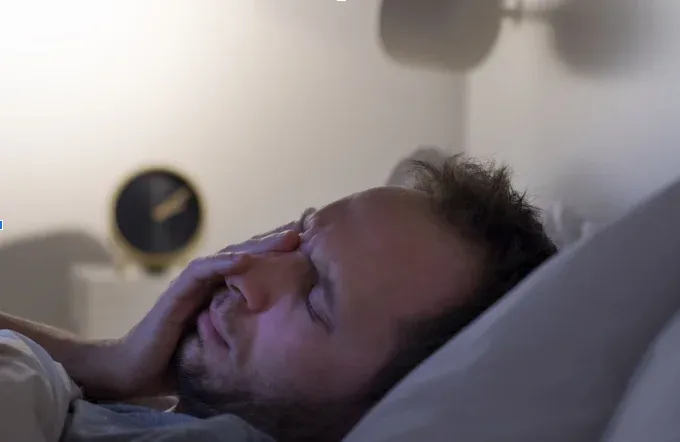 Man tired in bed