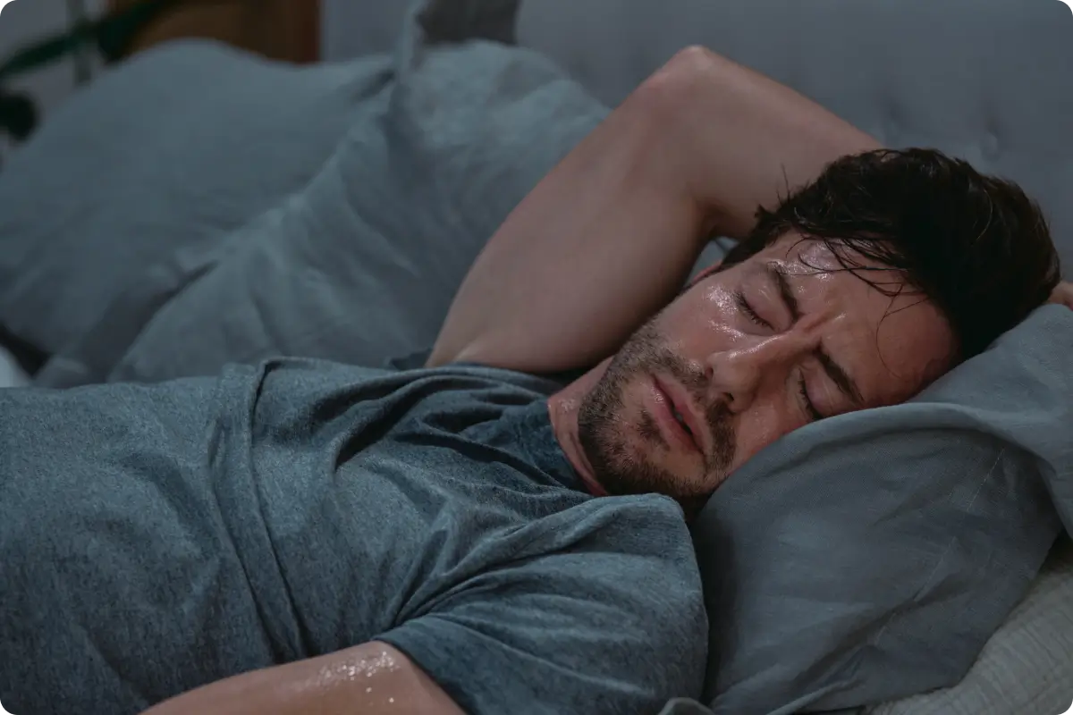 Man sweating in bed Man sweating in bed