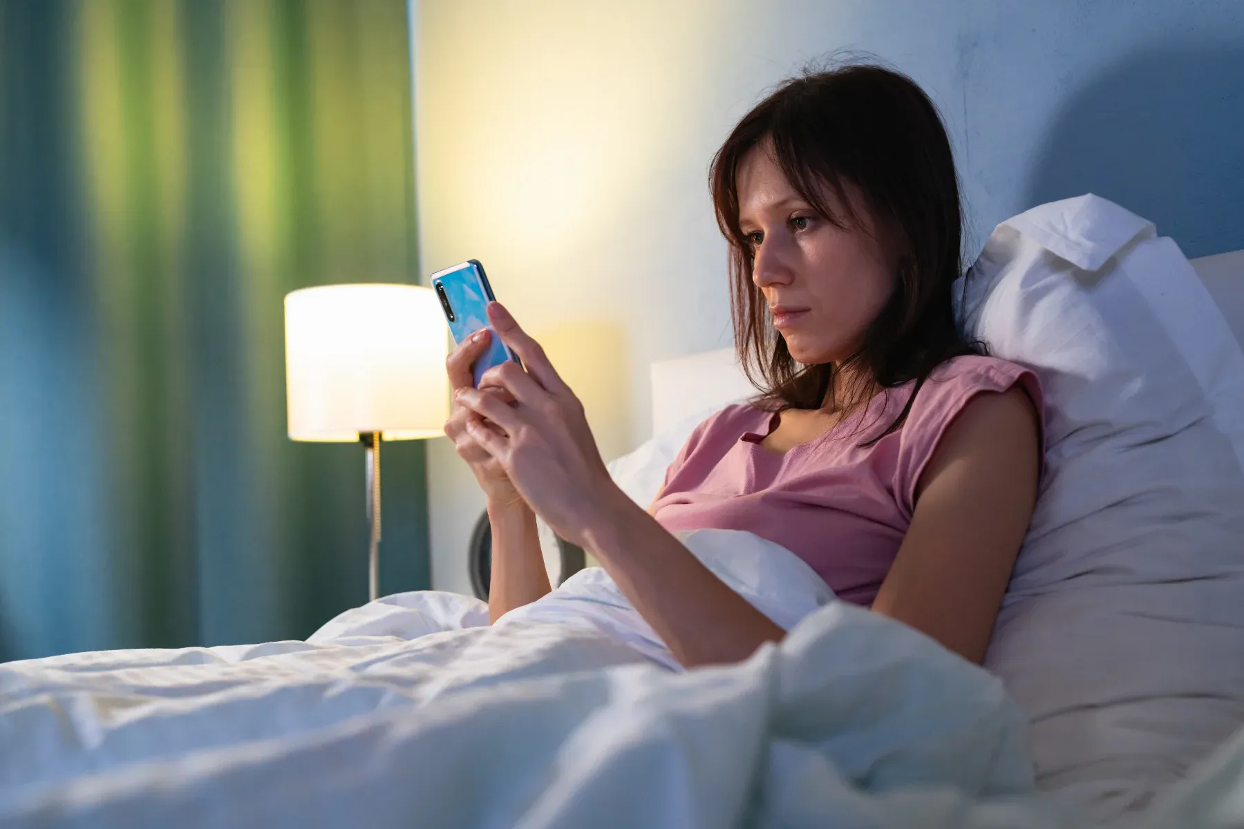 Scrolling social media in bed