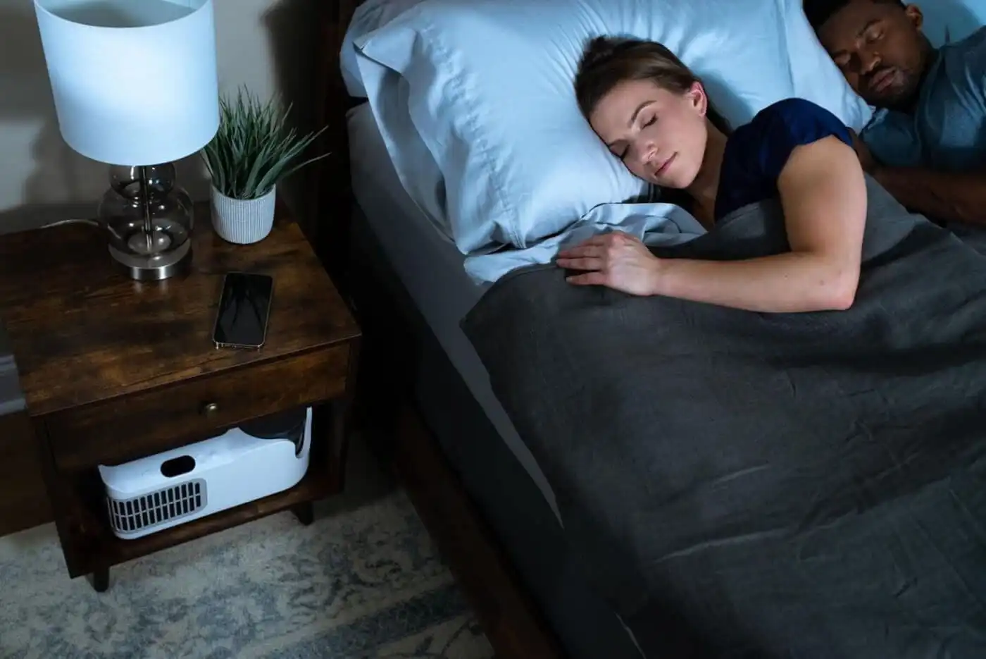 Woman sleeping with Chilipad to stay cool