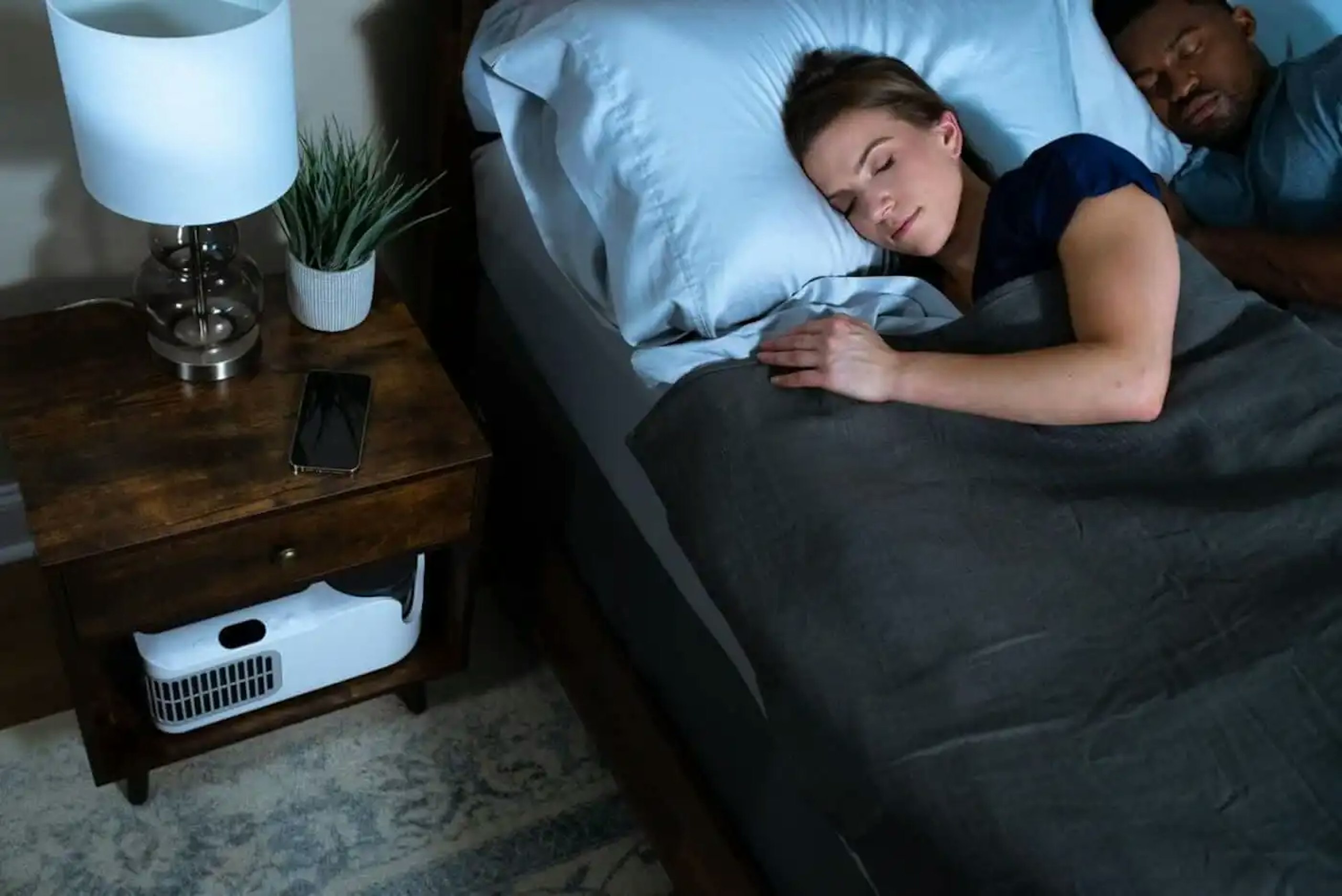 Woman sleeping with Chilipad to stay cool