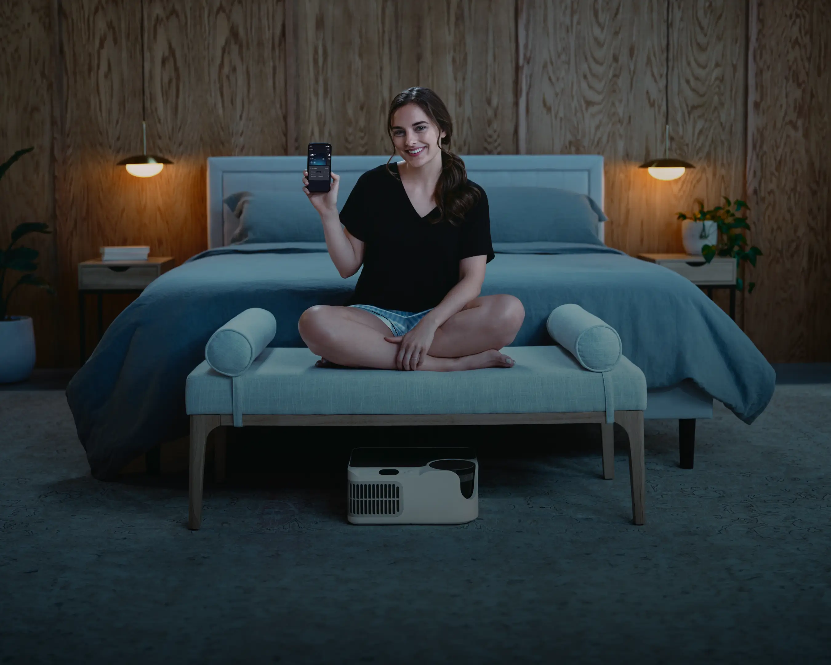 Woman using Chilipad app to control bed temperature with cooling sleep system under bed