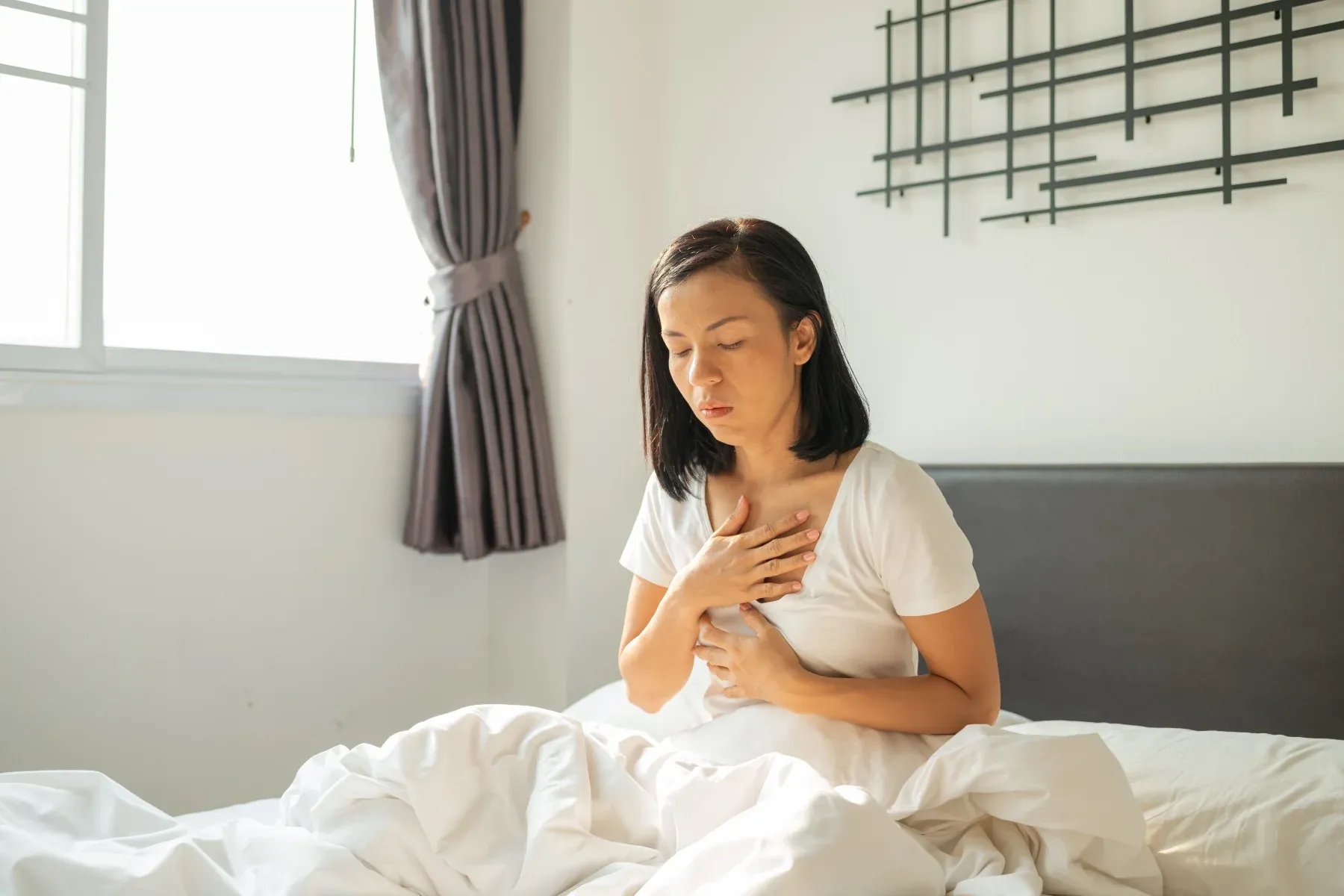 Women in bed with acid reflux