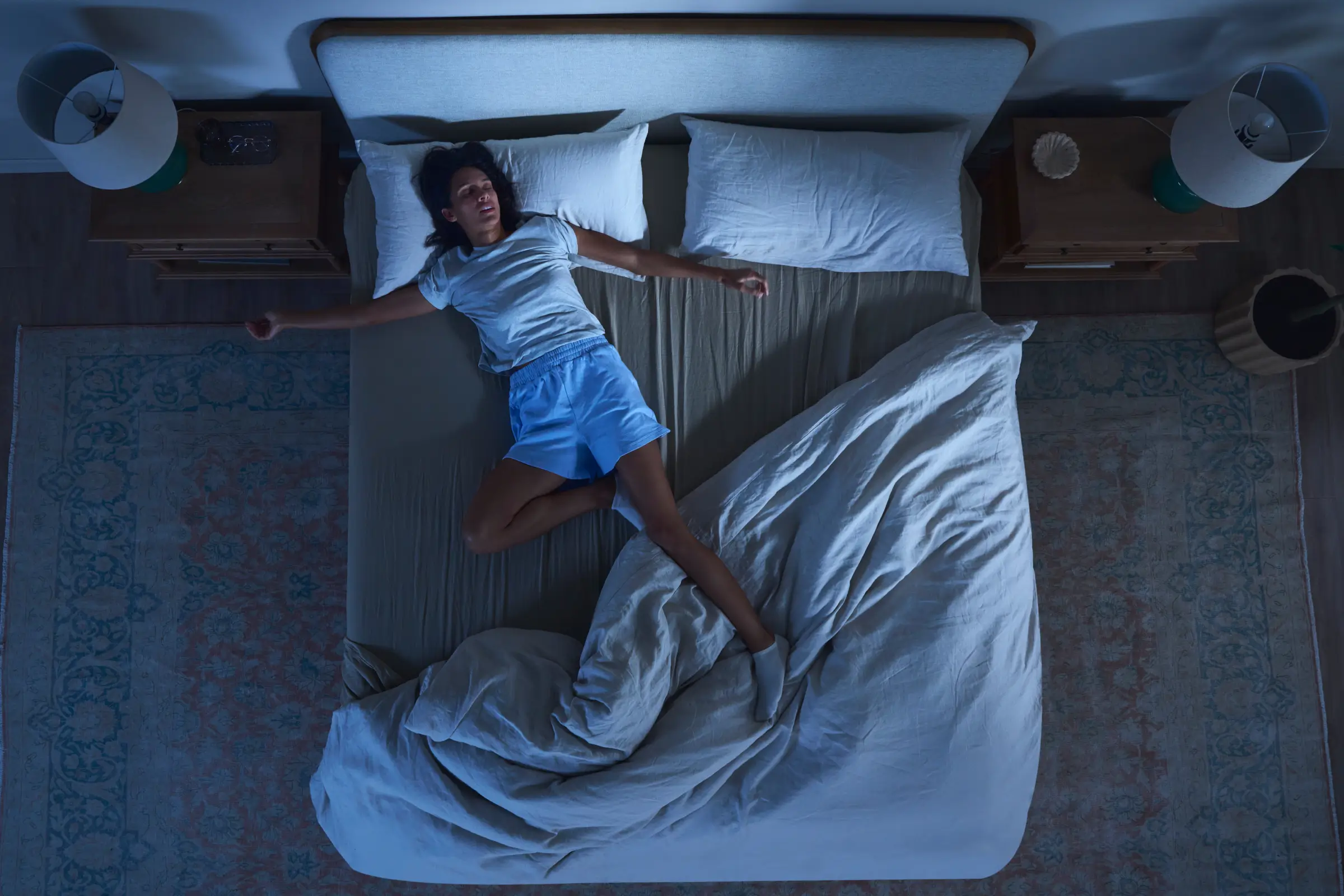 female feeling hot in the bed, unable to sleep