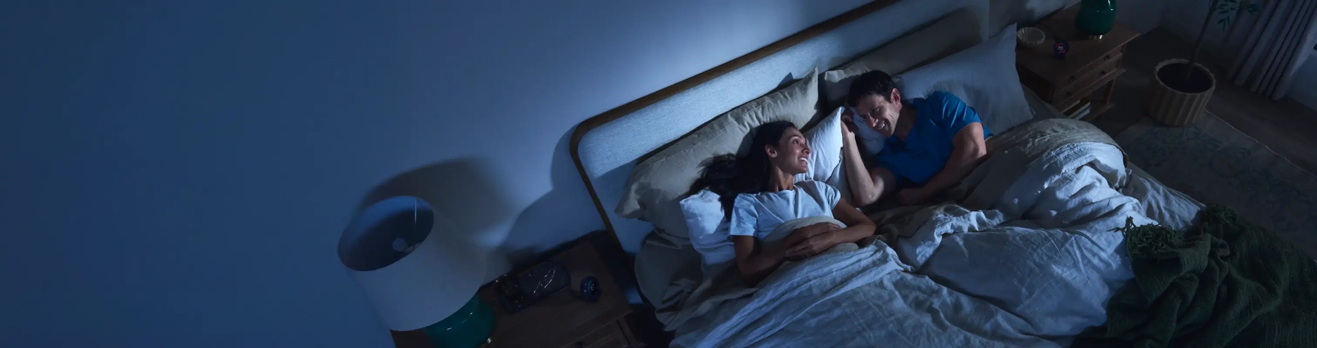 Couple in bed with customize bed temperature