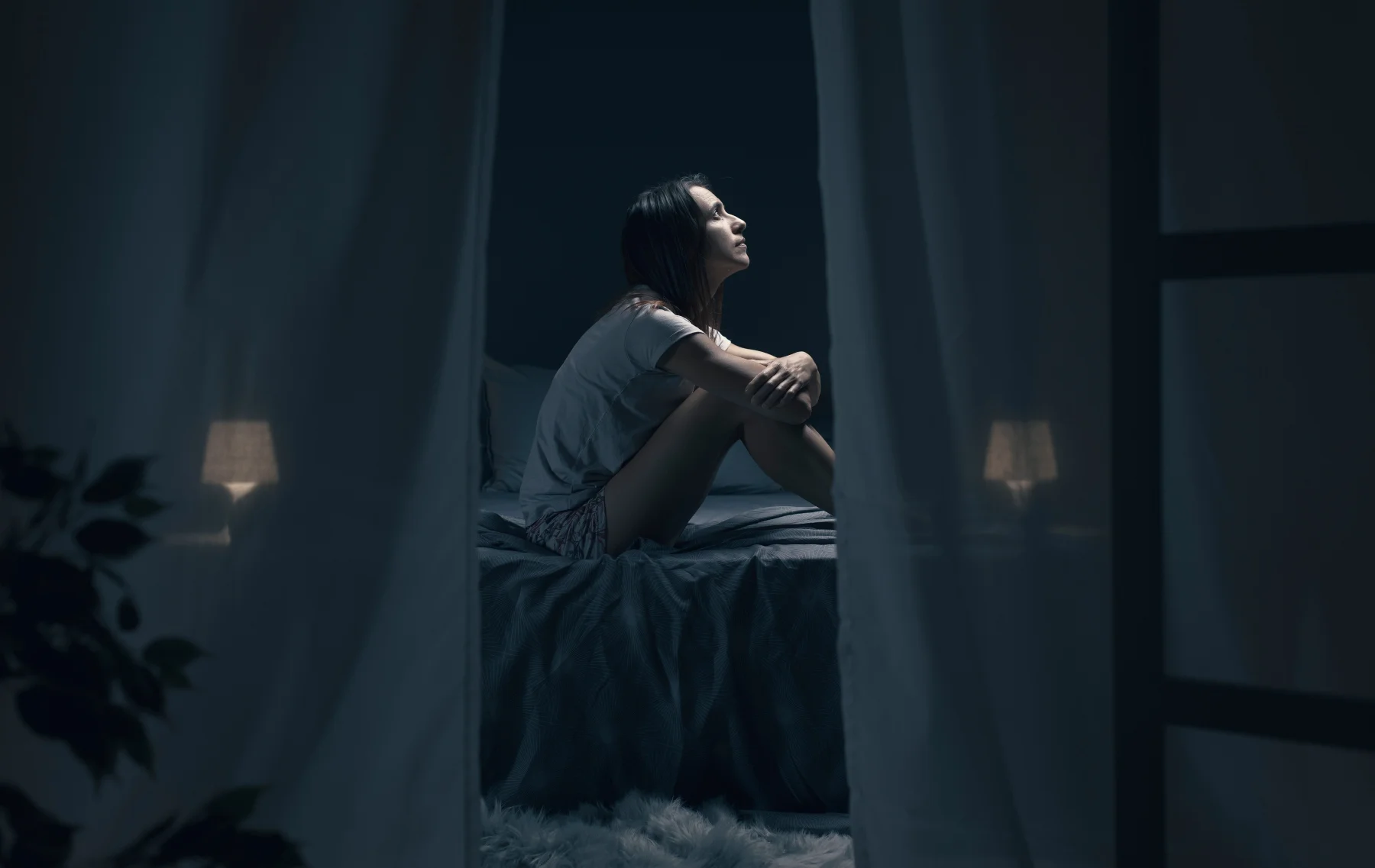 Woman experiencing nighttime overheating during perimenopause or menopause
