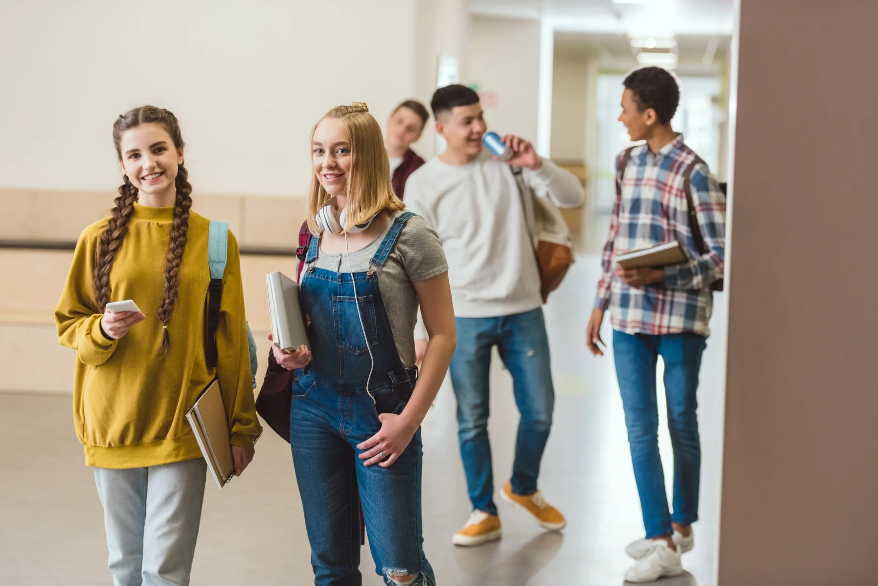 groups of teenagers in the school hall