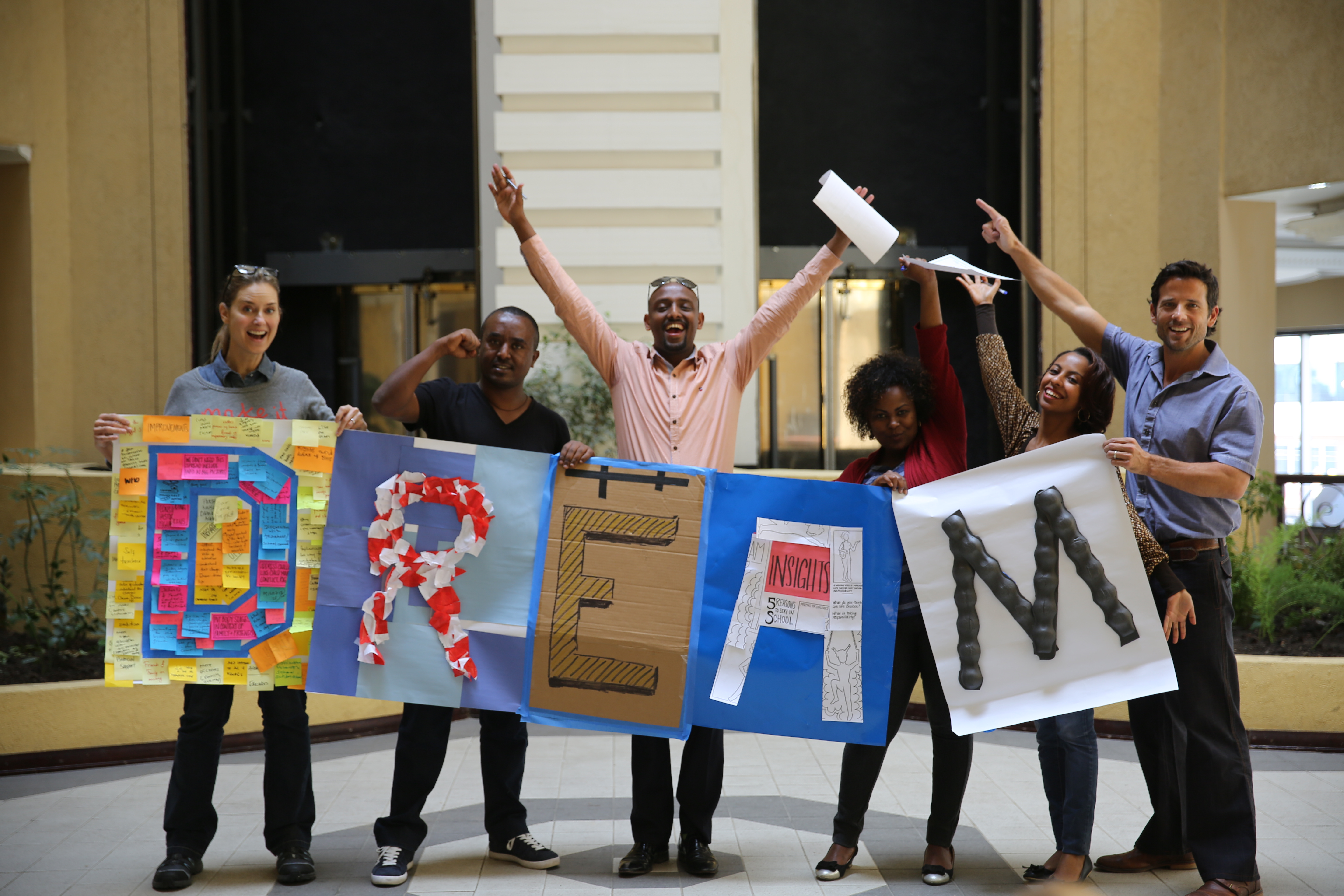 People holding up signs that spell the word dream