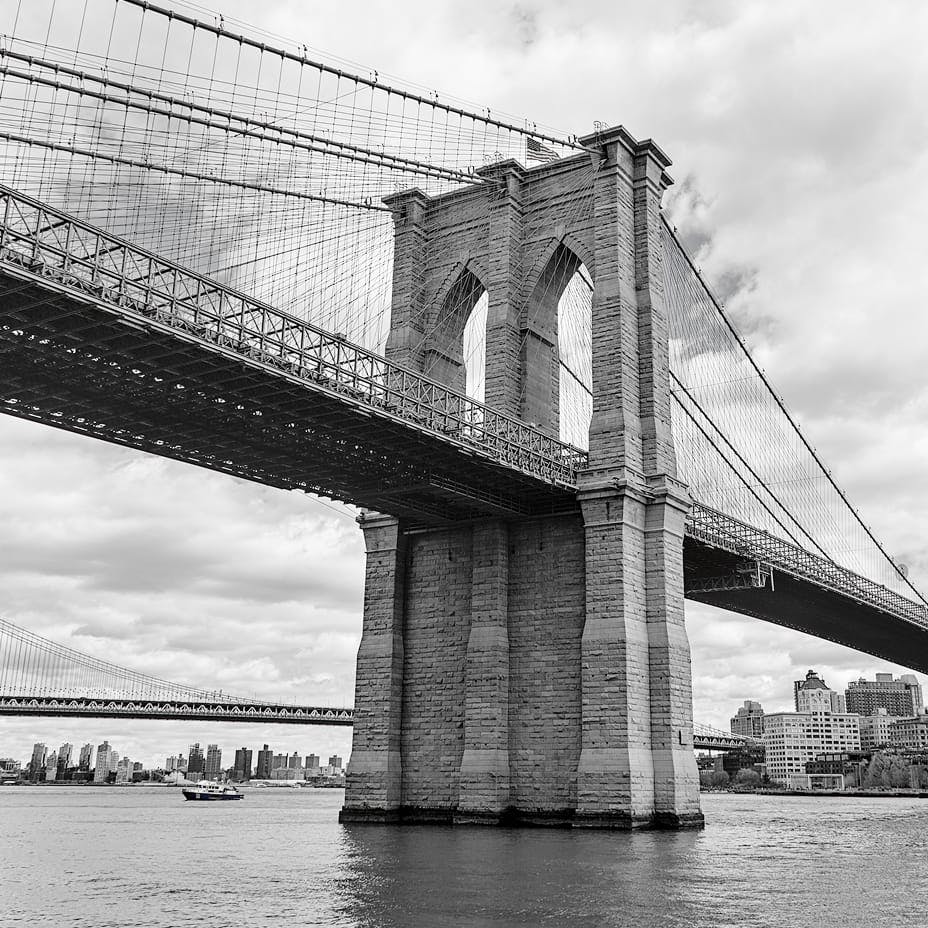 greyscale of bridge over the water