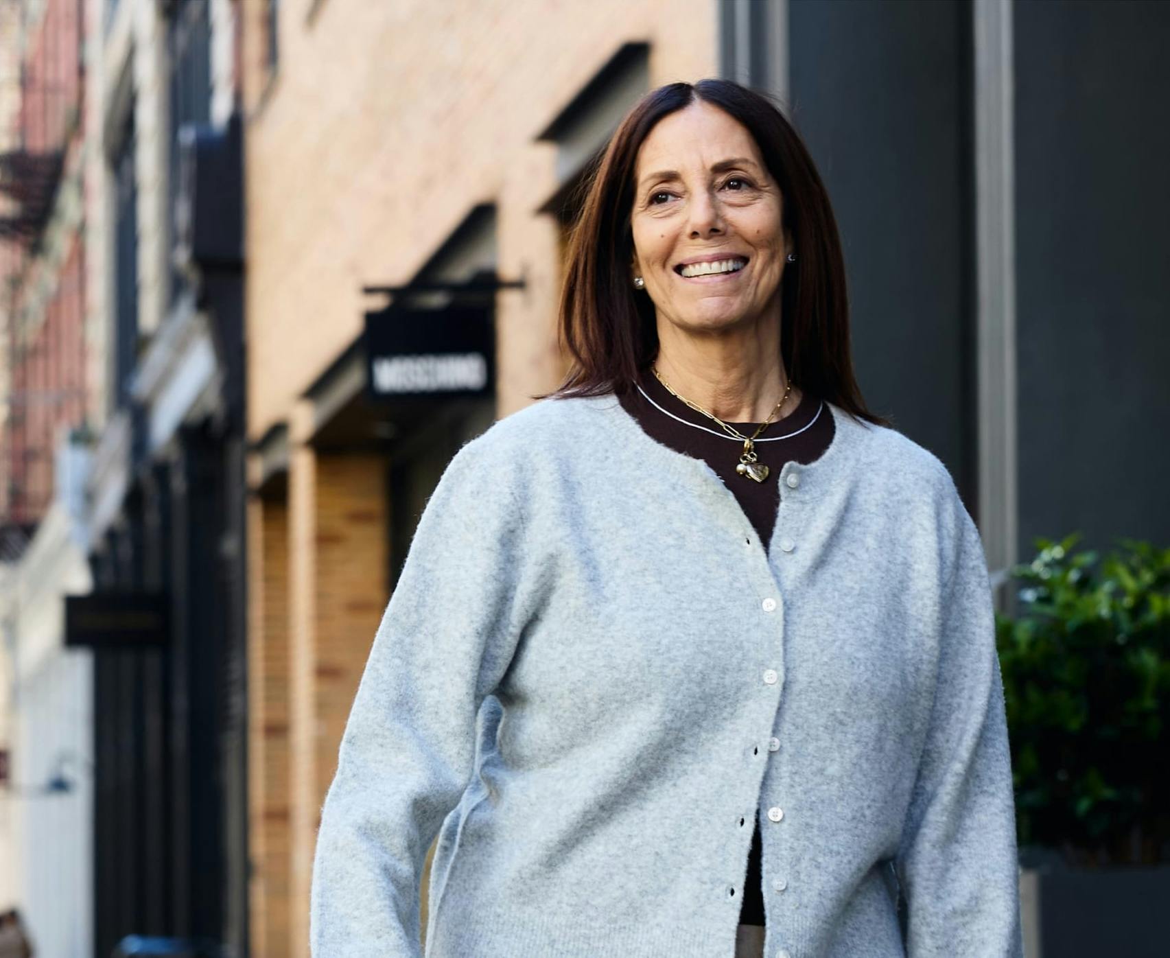 Woman in a sweater walking down the street