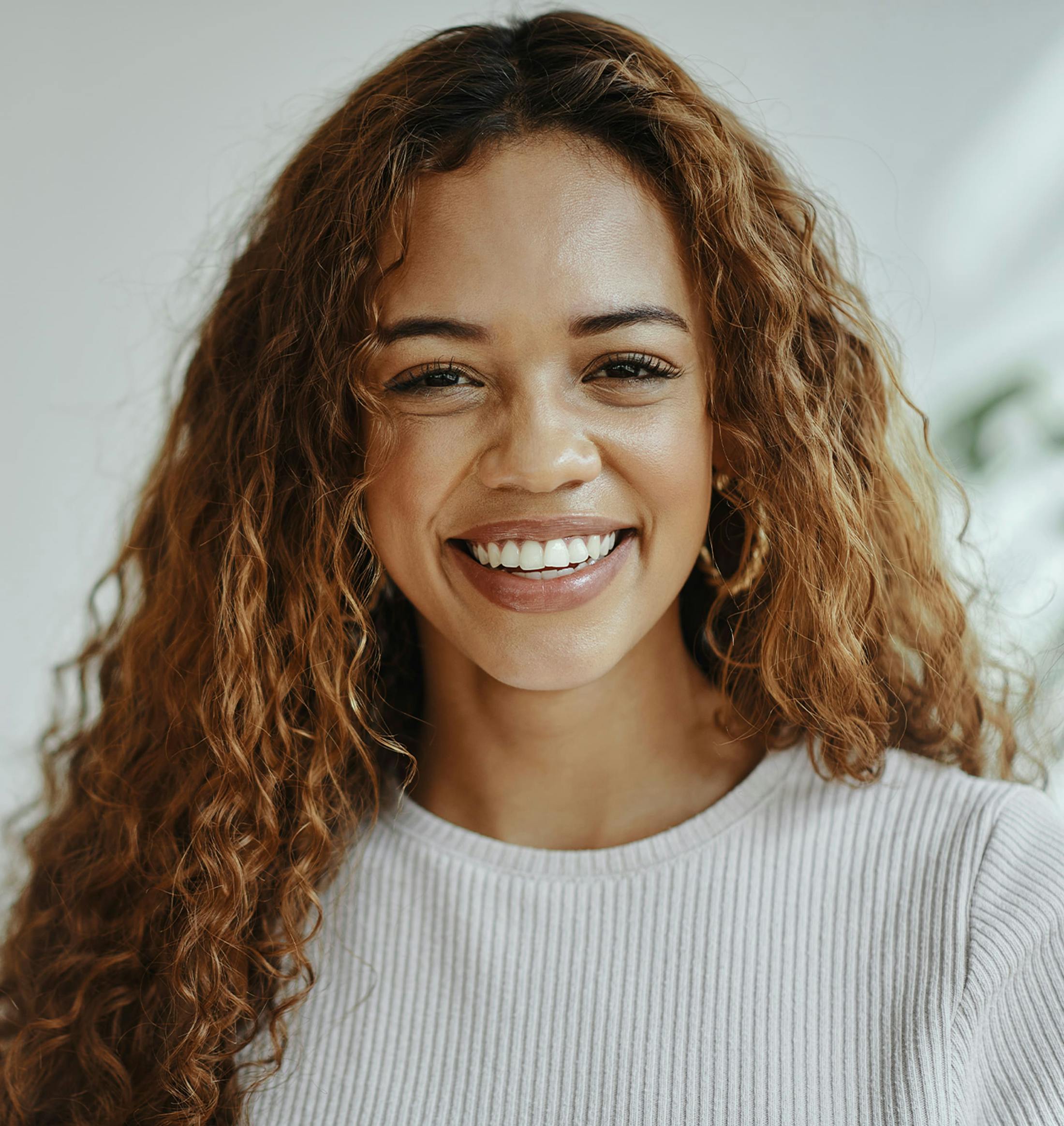 woman with curly hair smiling