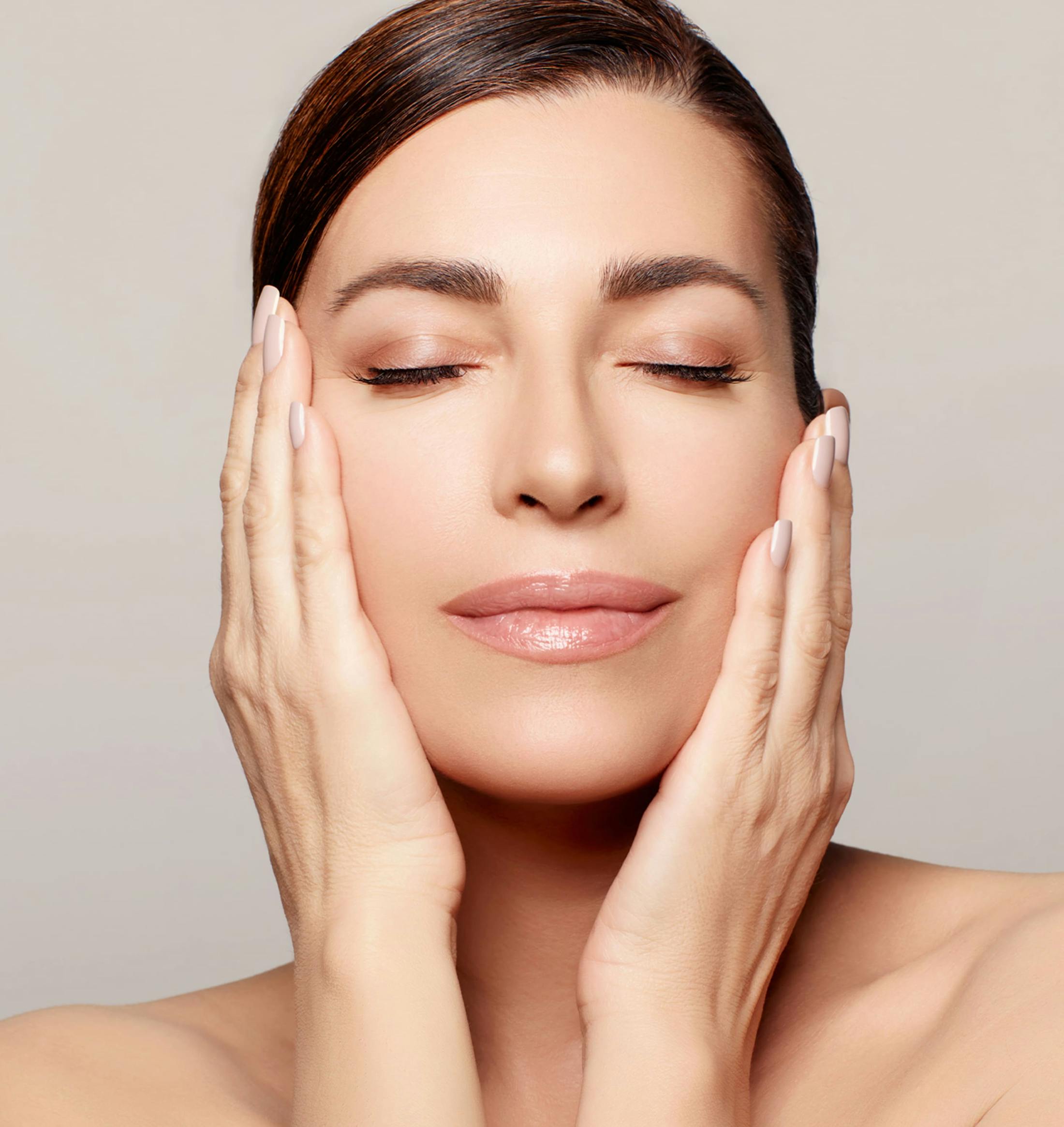 woman with her eyes closed and hands on her face