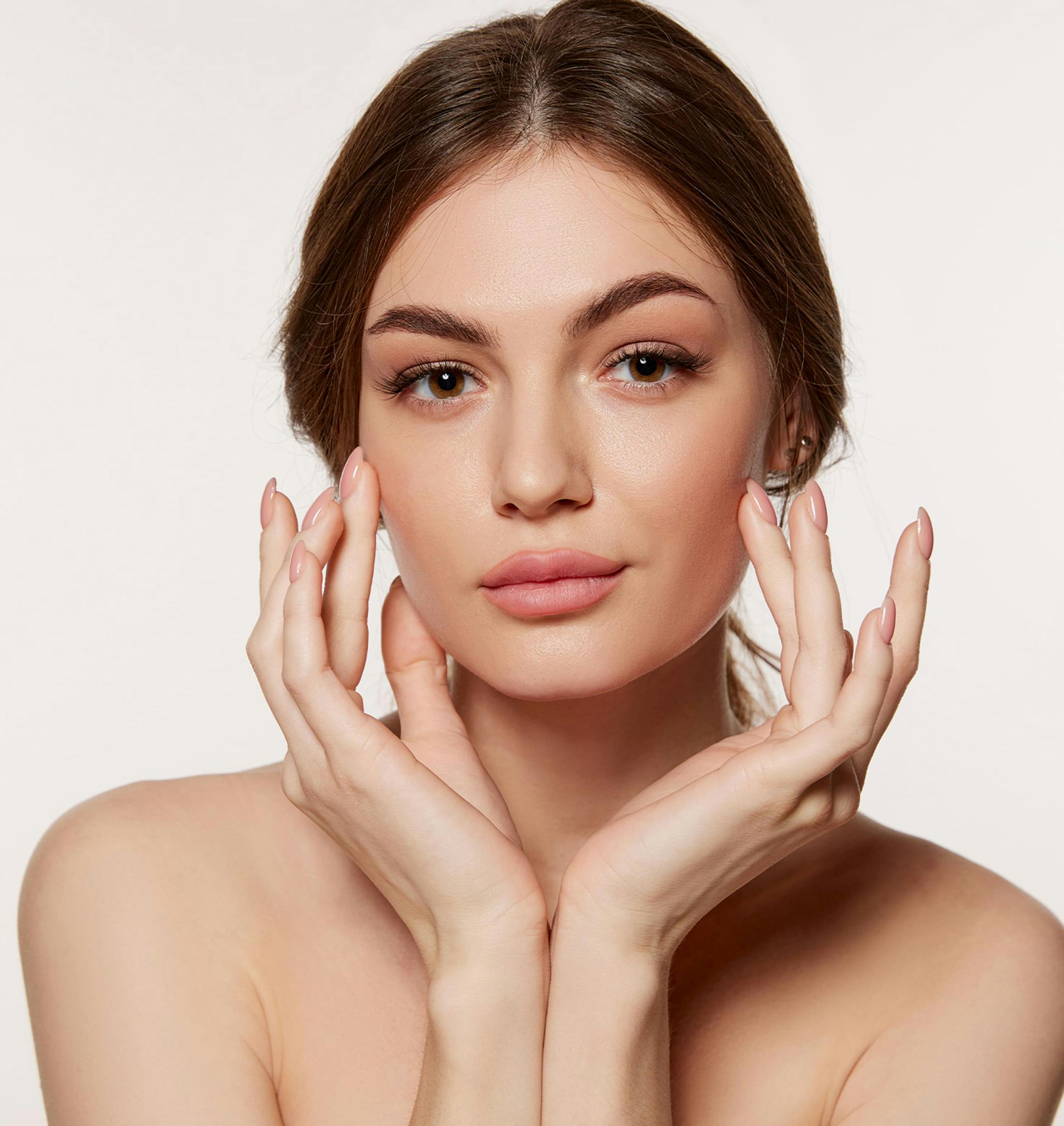 woman touching her cheeks with her fingers