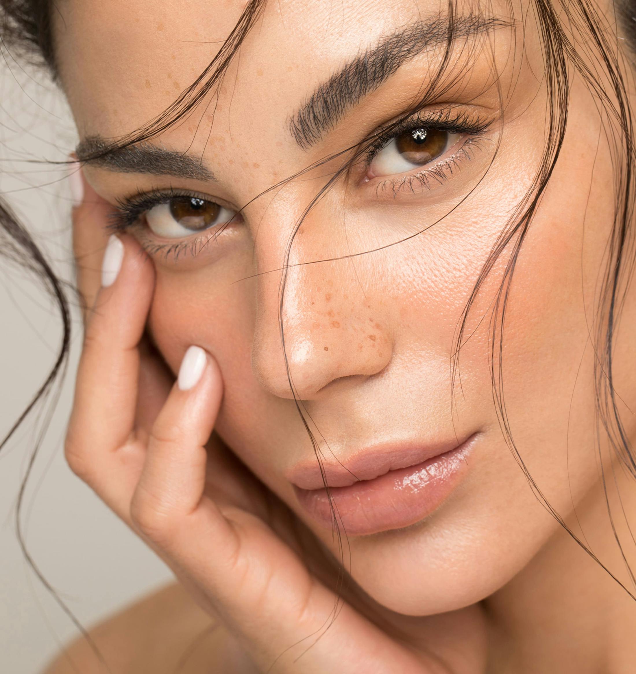 woman with her hand around her lower face