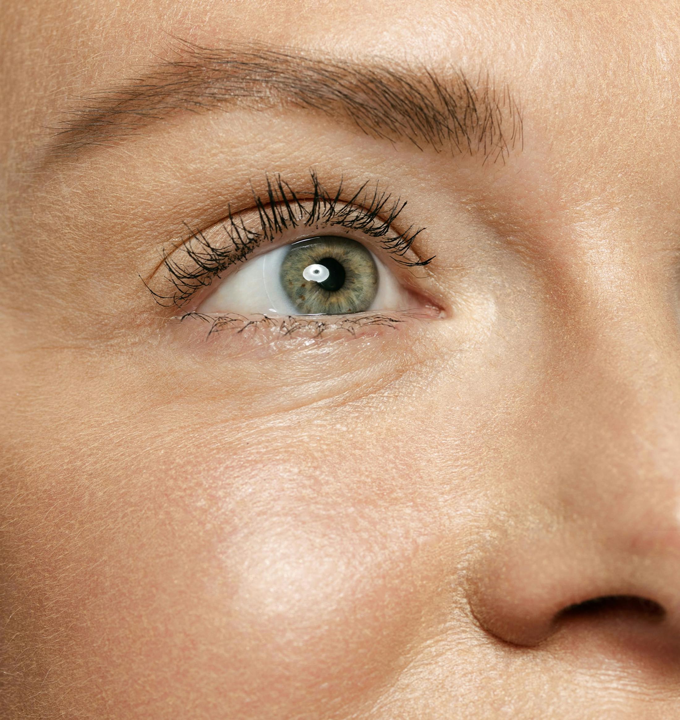 close up view on a woman's green eye