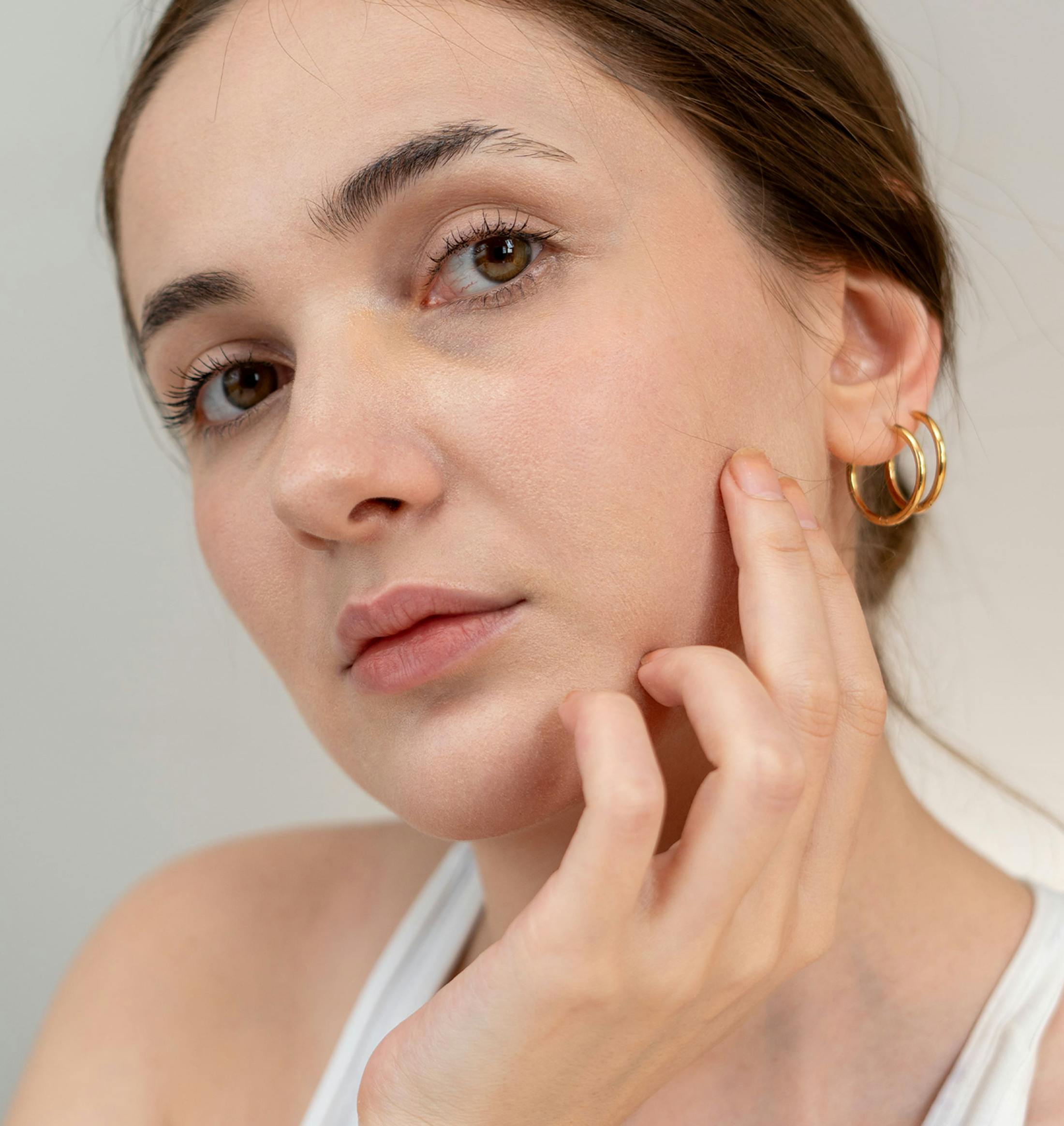 woman touching her cheek