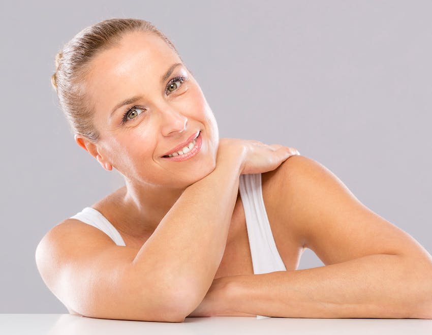 woman leaning on table with hand on shoulder
