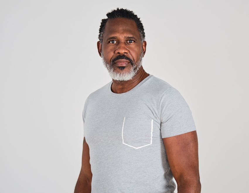 man looking forward in grey t-shirt