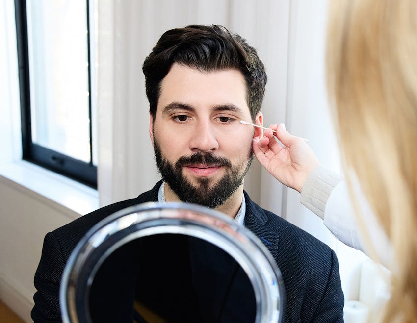 male patient getting his outer eye looked at by doctor