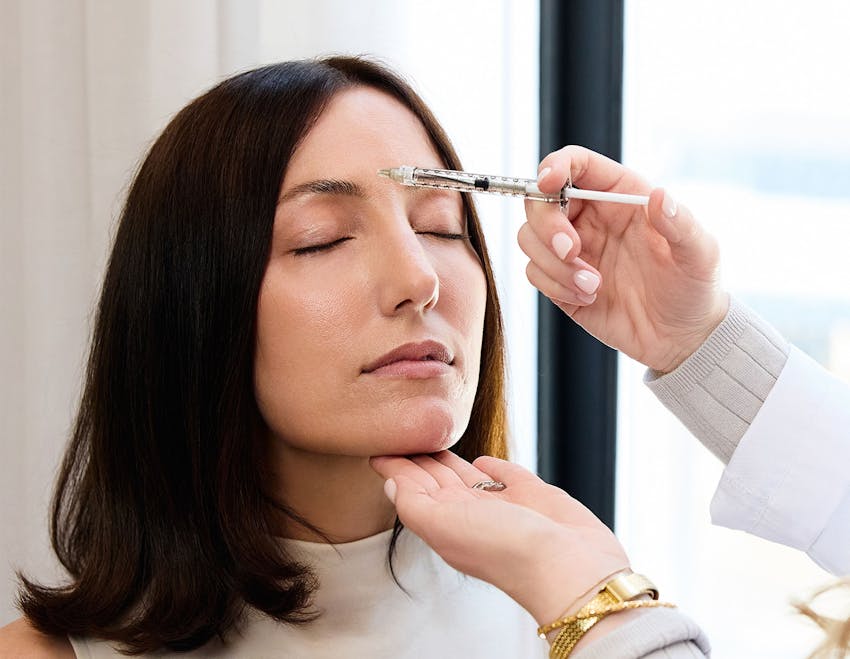 female patient getting injection on forehead