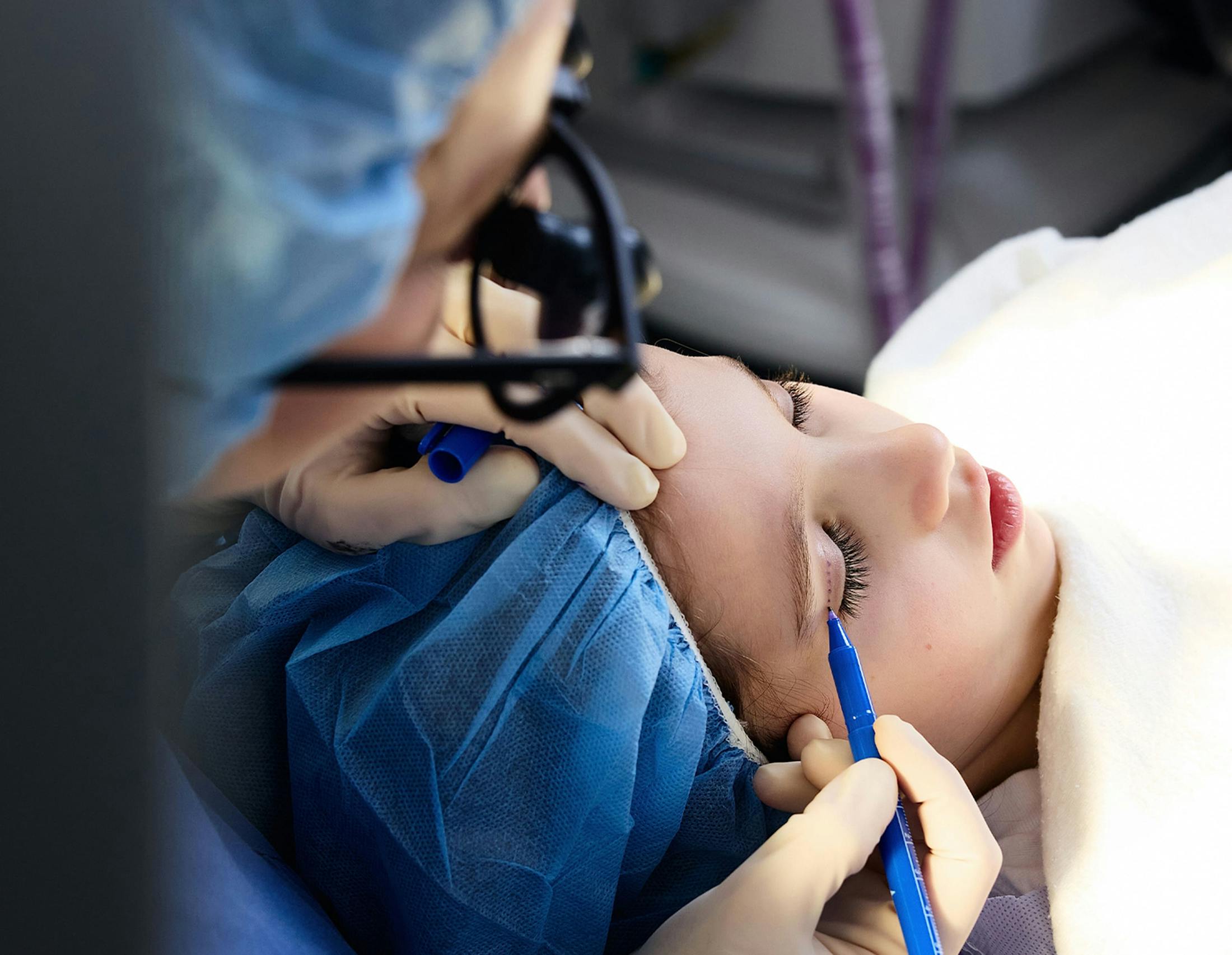 female patient getting her eyes procedure
