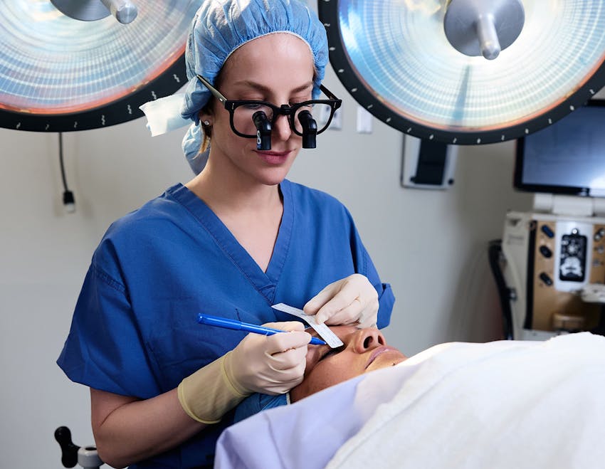 Dr. Allison doing procedure on female patient's eyelid