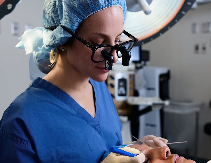 Dr. Allison looking at patient's eyes during procedure