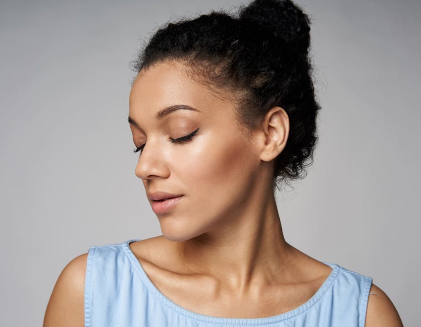 woman with her hair tied up and facing the left