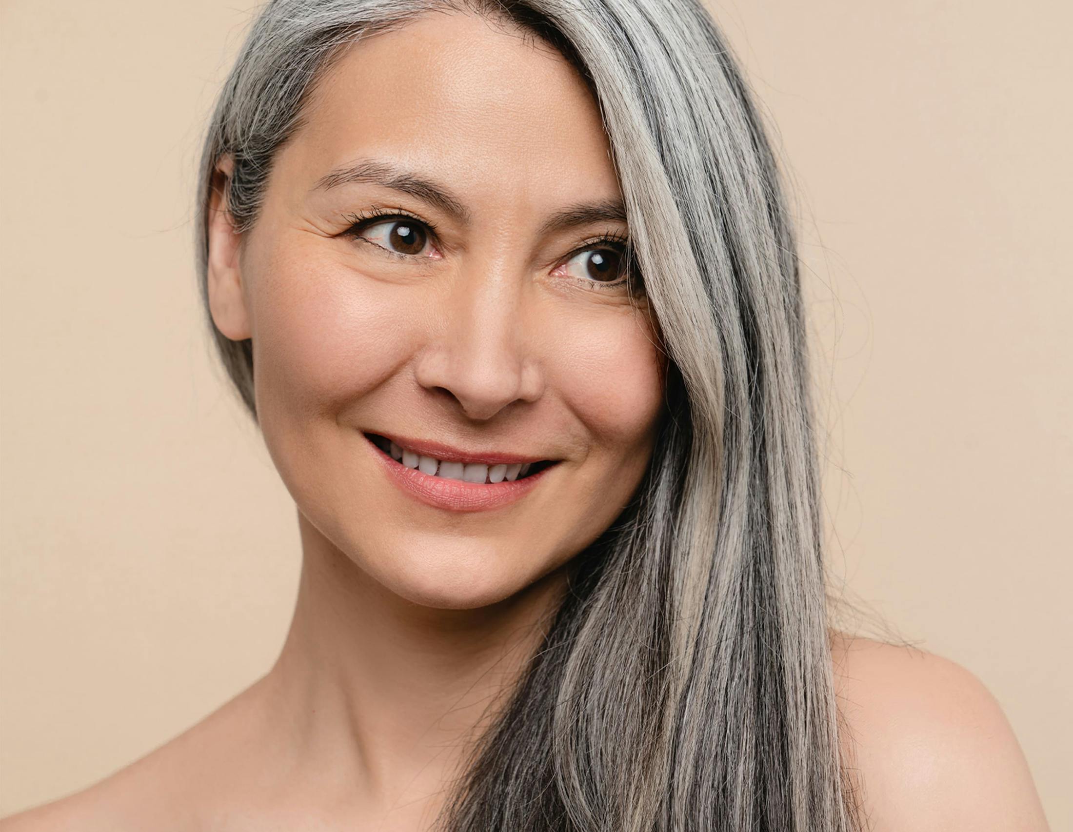 woman smiling with her hair on her left shoulder