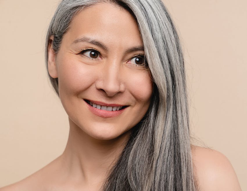 woman smiling with her hair on her left shoulder