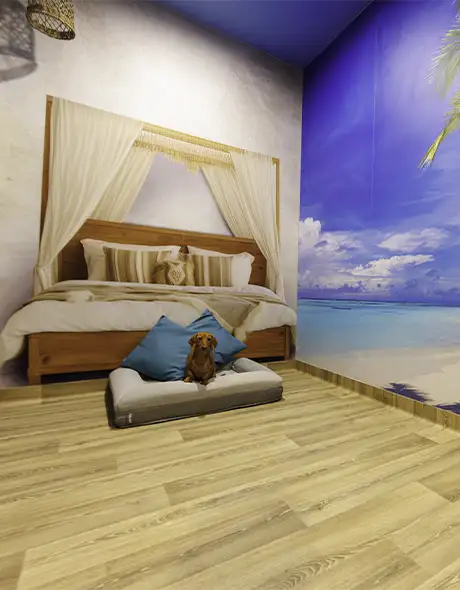 Small dog relaxing in the luxury “Dog Hotels of the World” suite at Pet Resorts Australia Port Melbourne, a premium dog boarding option featuring themed rooms, deluxe bedding, and five-star comfort for pets in Melbourne.
