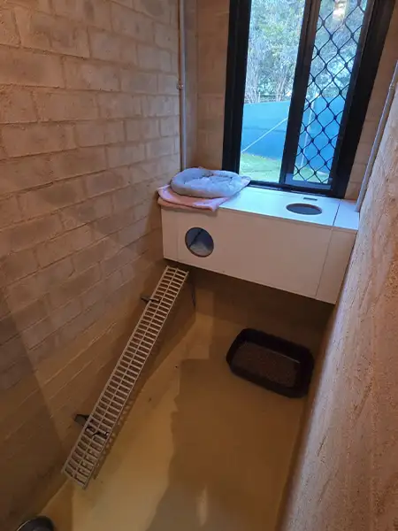 A clean and warm cat guest suite showing a hide box and warm bedding at Pet Resorts Australia Southern Highlands